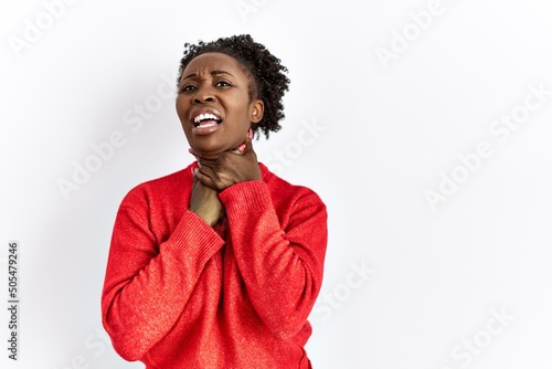 Young african american woman wearing casual clothes over isolated background shouting and suffocate because painful strangle. health problem. asphyxiate and suicide concept.