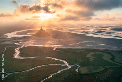 Aerial distant view of the Mont Saint-Michel during sunset in Normandy, France
