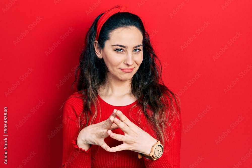 Young hispanic woman wearing casual clothes hands together and fingers crossed smiling relaxed and cheerful. success and optimistic Young hispanic woman wearing casual clothes hands together and fingers crossed smiling relaxed and cheerful. success and optimistic