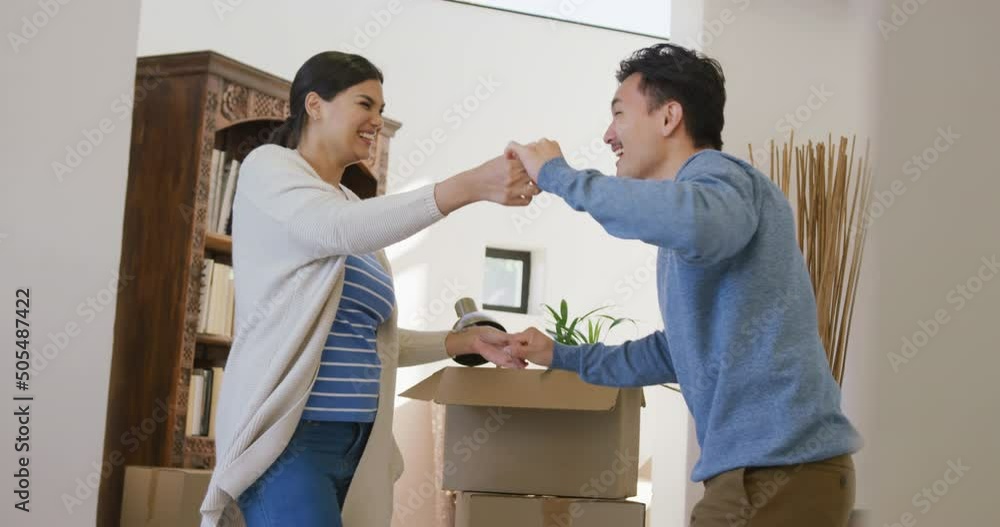 Video of happy diverse couple danging with joy in new house Video of happy diverse couple danging with joy in new house