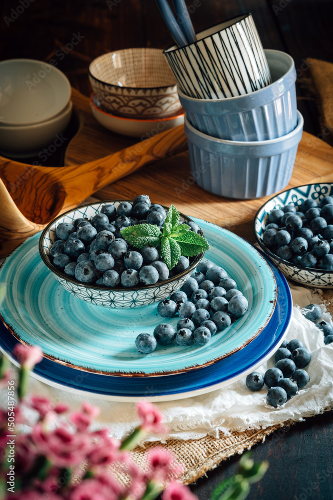 Bilberries in bowls over the table - close up Bilberries in bowls over the table - close up