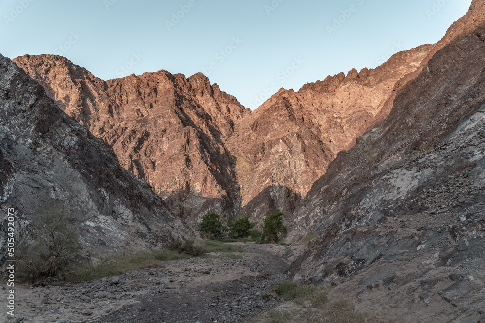 Nature in Muscat. A lot of rocky hills and a beautiful blue sea. 