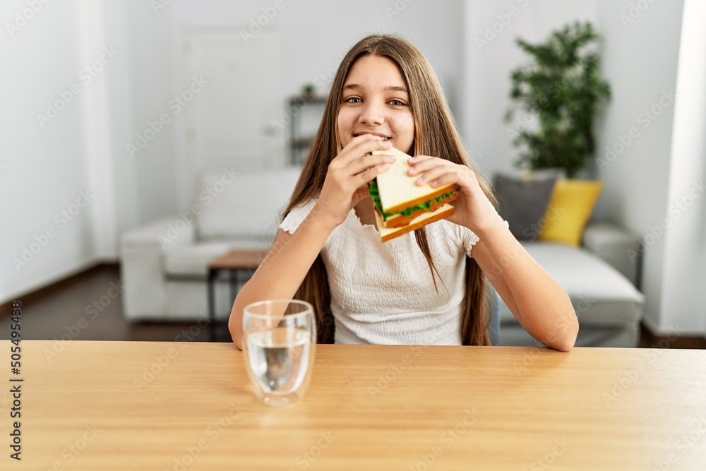 Adorable girl smiling confident sitting on table at home Adorable girl smiling confident sitting on table at home