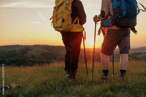 Unrecognized couple with backpackers exploring nature together © bernardbodo