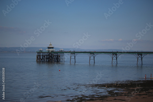 Clevedon pier putside of Bristol in South West England under the scorching sun on a clear summers day as the river servern lazily flows by photo