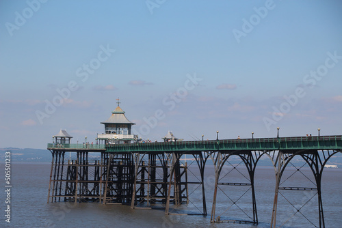 Clevedon pier putside of Bristol in South West England under the scorching sun on a clear summers day as the river servern lazily flows by photo