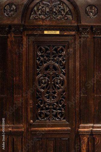 Vertical shot of a confessional cabinet in a church in the Principality of Monaco photo