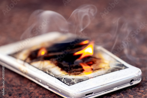 Mobile phone  smartphone  on fire. Burning smartphone