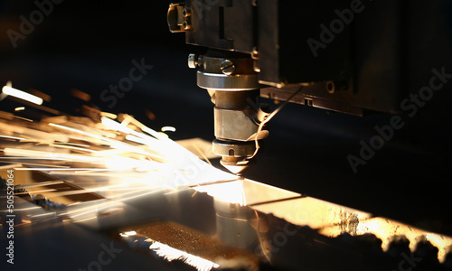 Neon sparks fly out machine head, equipment for metal processing laser metal