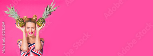 Fashion portrait funny woman with pineapple banner over pink background with copy space and place for advertising