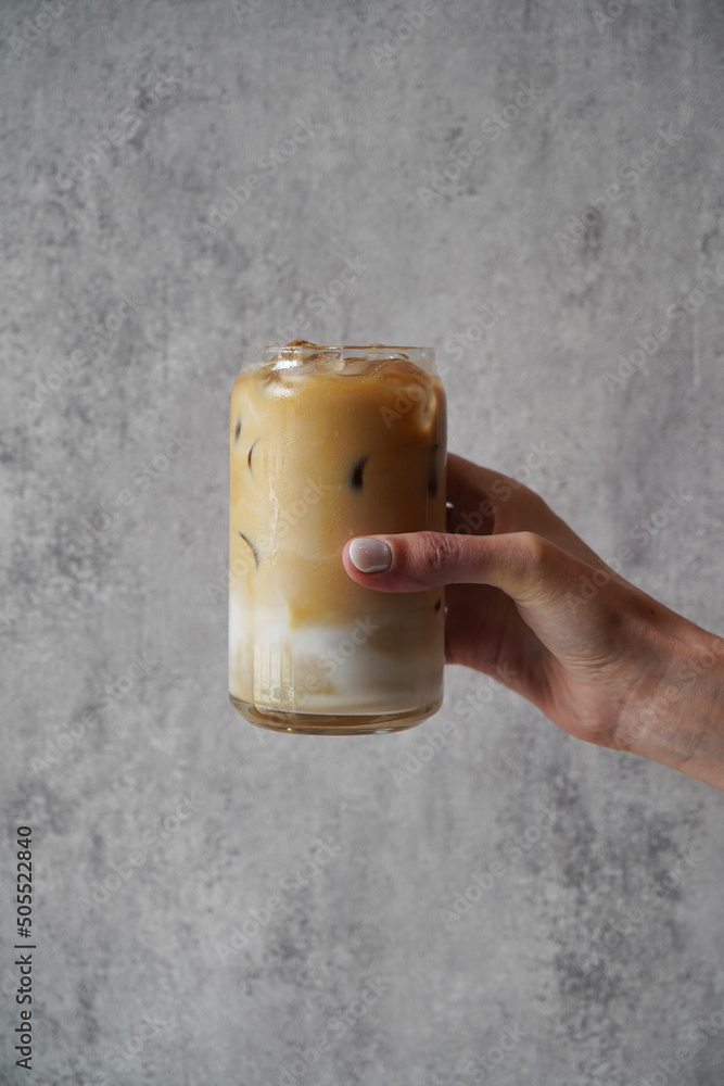 Hand with Ice coffee glass, close-up - obrazy, fototapety, plakaty 