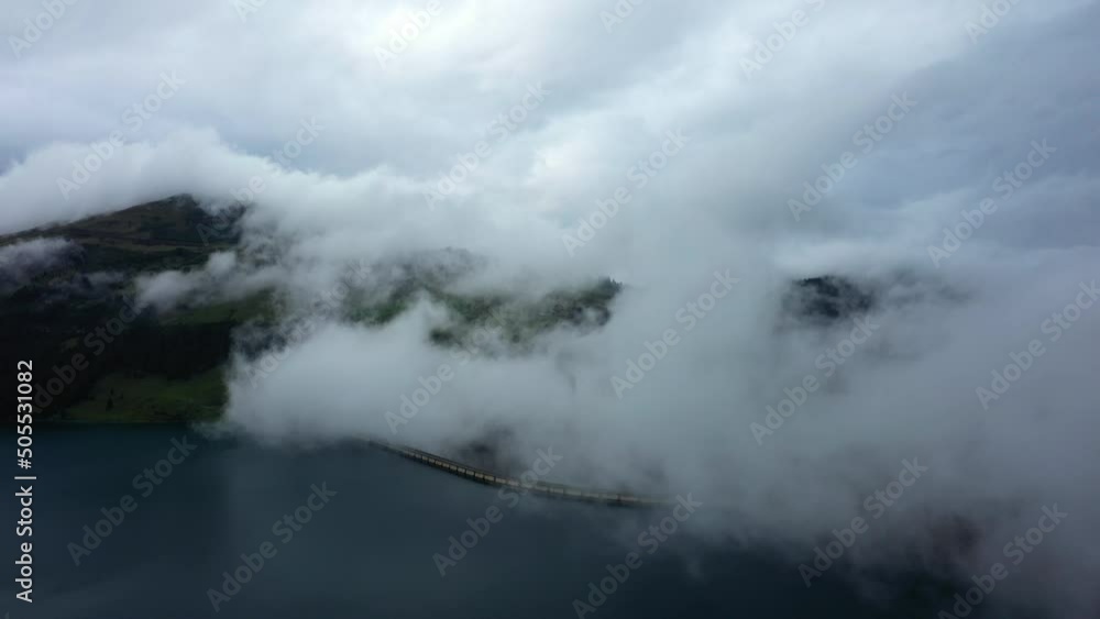 Clouds over Lake Roselend in Europe, France, the Alps, Savoie, in winter, on a cloudy day. Clouds over Lake Roselend in Europe, France, the Alps, Savoie, in winter, on a cloudy day.