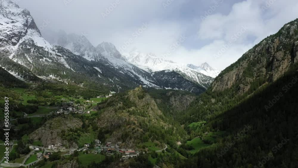 A medieval tower above the Valley in the Alps in Europe, Italy, the Aosta Valley, in winter, on a sunny day. A medieval tower above the Valley in the Alps in Europe, Italy, the Aosta Valley, in winter, on a sunny day.