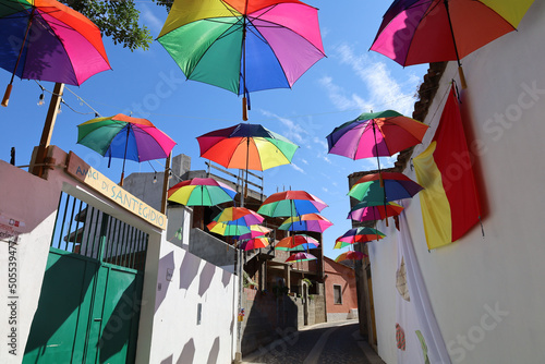 Colourful umbrellas decorating the blue Sky in Muravera Sardinia photo