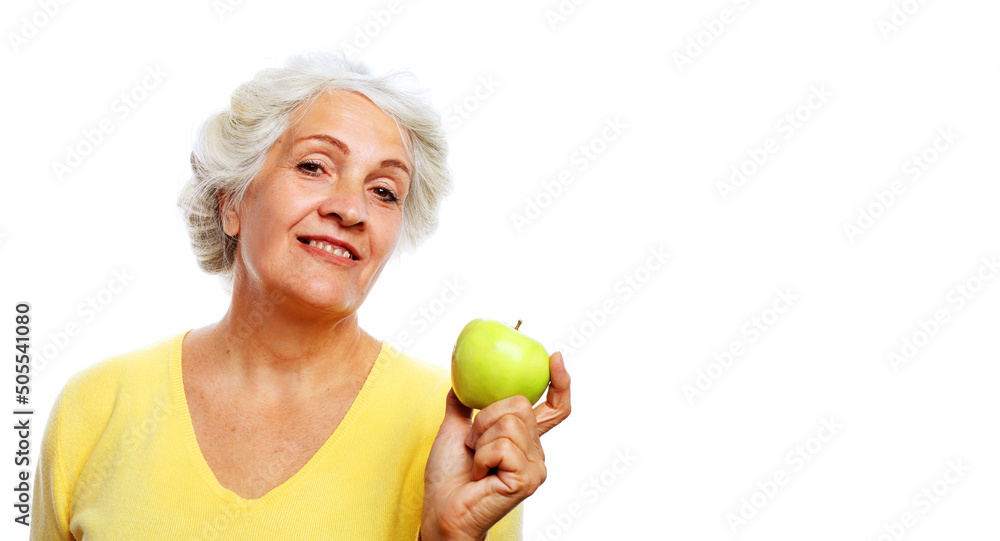 Portrait of a beautiful elderly woman holding an apple, smiling, isolated on white background. Portrait of a beautiful elderly woman holding an apple, smiling, isolated on white background.