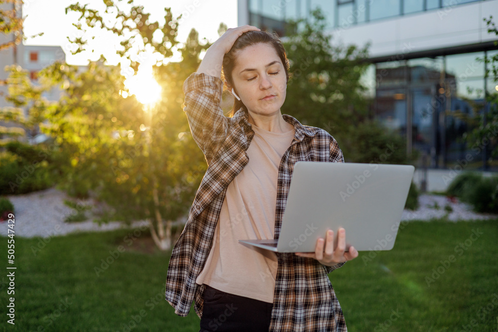 Front view. A girl in a shirt with a laptop on the street working. Remote work. c
Сonducting online video calls. Freelance girl. Front view. A girl in a shirt with a laptop on the street working. Remote work. c
Сonducting online video calls. Freelance girl.