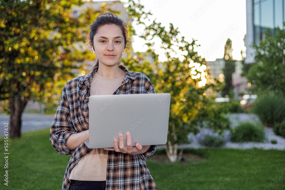 Front view. A girl in a shirt with a laptop on the street working. Remote work. c
Сonducting online video calls. Freelance girl. Front view. A girl in a shirt with a laptop on the street working. Remote work. c
Сonducting online video calls. Freelance girl.
