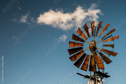 Closeup of a windmill with a blue sky background