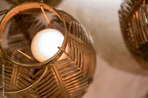 copper lanterns with candles at night close up with grain and ou photo