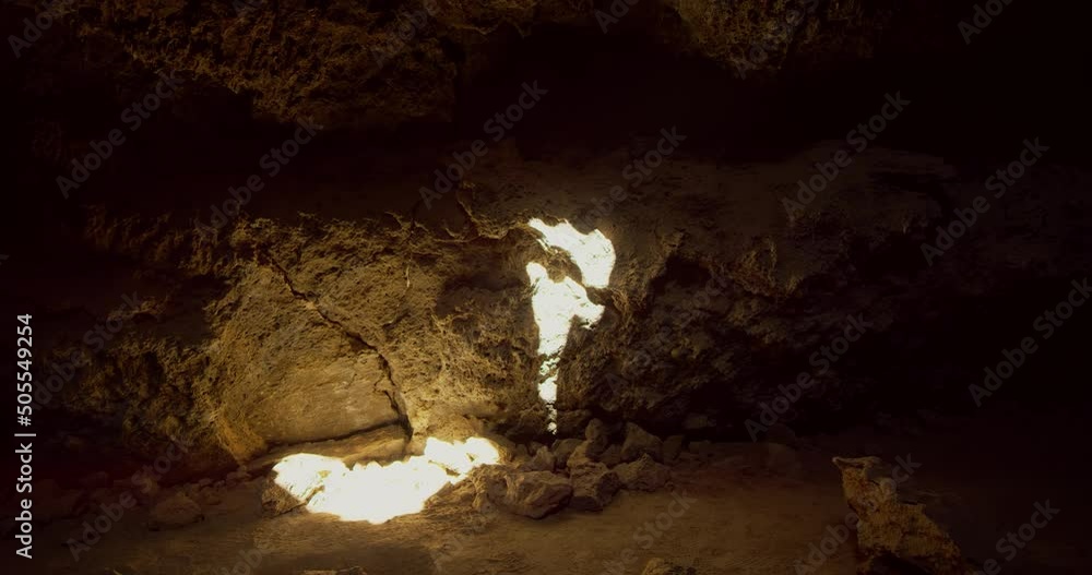 A sunbeam enters through the ceiling of a lava tube in Mojave National Preserve, California A sunbeam enters through the ceiling of a lava tube in Mojave National Preserve, California