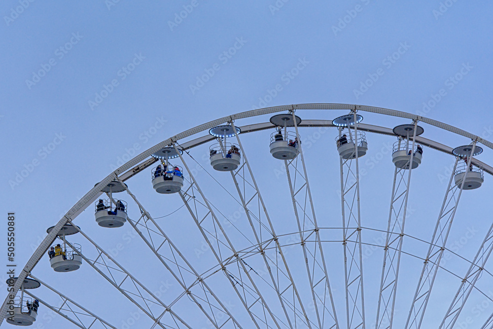 detail of a ferris wheel on a clear blue sky