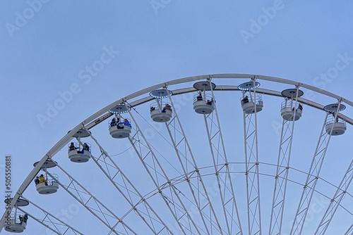 detail of a ferris wheel on a clear blue sky