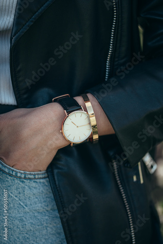 Classic beautiful elegant white watch on woman hand. Close-up photo.