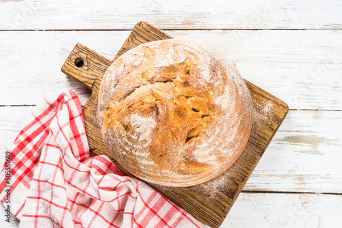 Homemade bread at white wooden table. photo