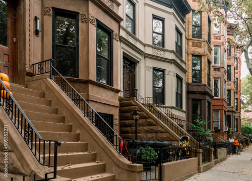Scenic view of a classic Brooklyn brownstone block with a long facade and ornate stoop balustrade in Park Slope neighborhood, New York, USA photo