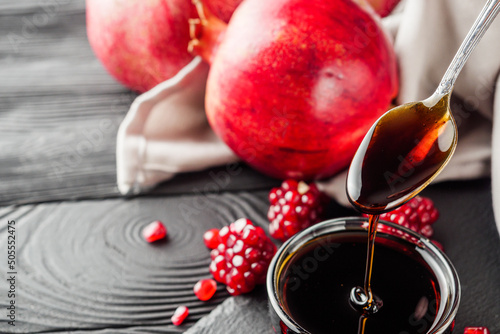 fresh pomegranate sauce narsharab on a black wooden rustic background photo