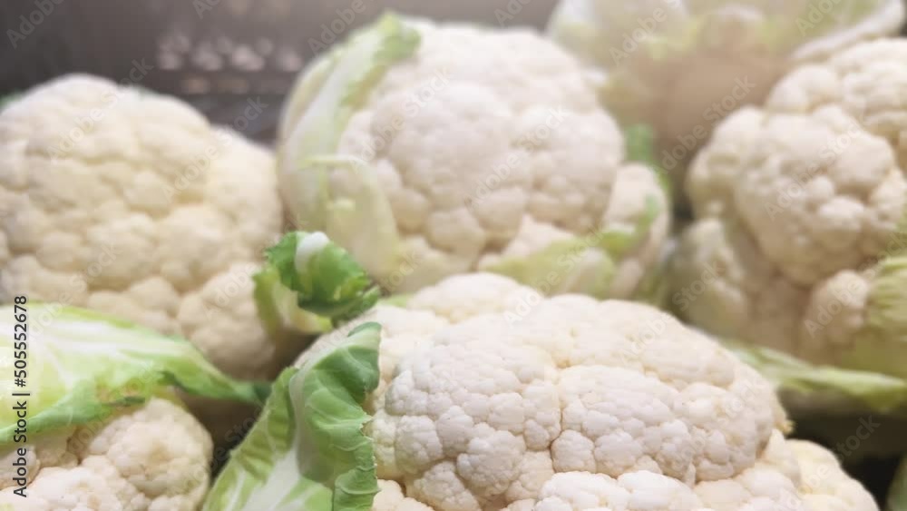 Cauliflower lies in baskets on the shelves of a supermarket or greengrocer. Closeup Cauliflower lies in baskets on the shelves of a supermarket or greengrocer. Closeup