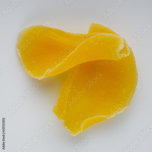 delicious dried mango on a white acrylic background