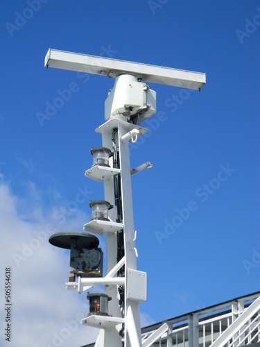 Closeup of a marine radar against a bright blue sky