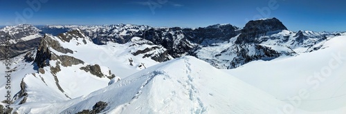 Ski mountaineering on the Bocktschingel in Glarus Uri. Winter mountain landscape with a view of the snowy glaciers.