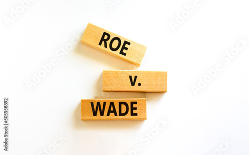 Abortion process Roe versus Wade symbol. Concept words Roe versus Wade on wooden blocks. Beautiful white table white background. Abortion process Roe versus Wade concept. Copy space.