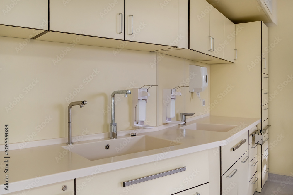 elbow soap and antiseptic dispenser or sanitizer wall mounted for hand disinfection and water tap sink with faucet bathroom or clinic elbow soap and antiseptic dispenser or sanitizer wall mounted for hand disinfection and water tap sink with faucet bathroom or clinic