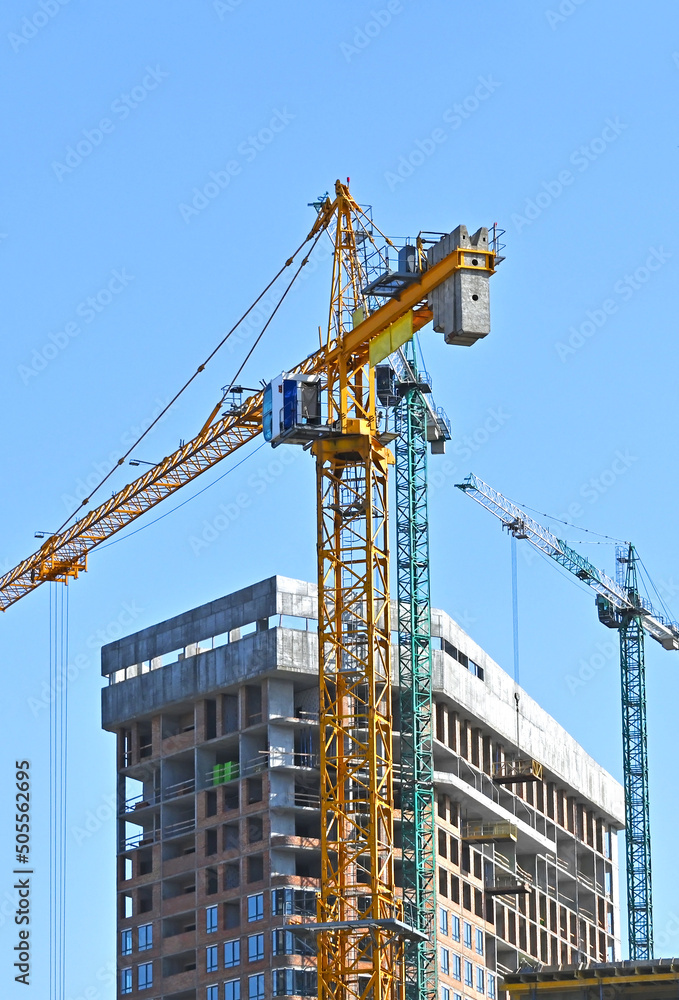 Crane and highrise construction site Crane and highrise construction site