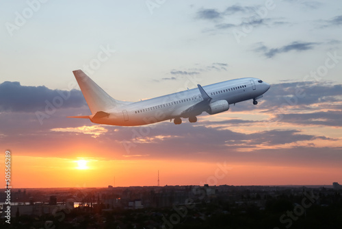 View of flying airplane at sunset