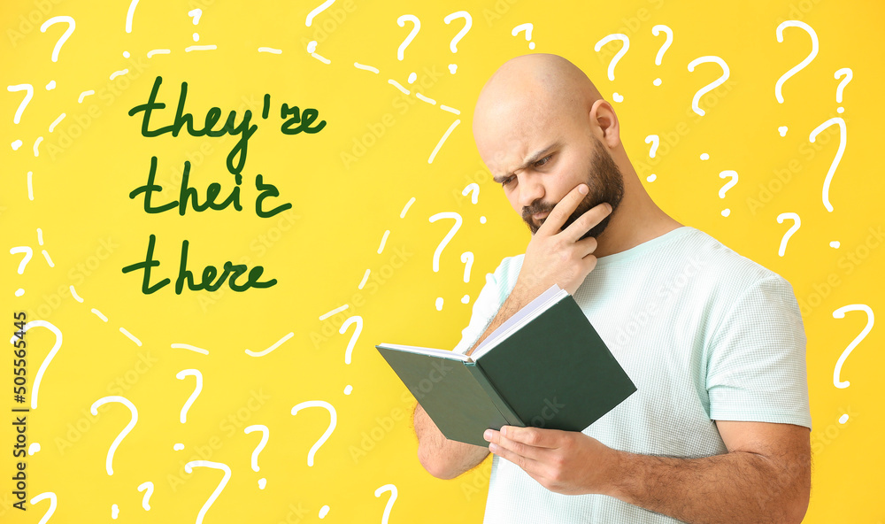 Αυτοκόλλητο Thoughtful man studying English grammar on yellow background