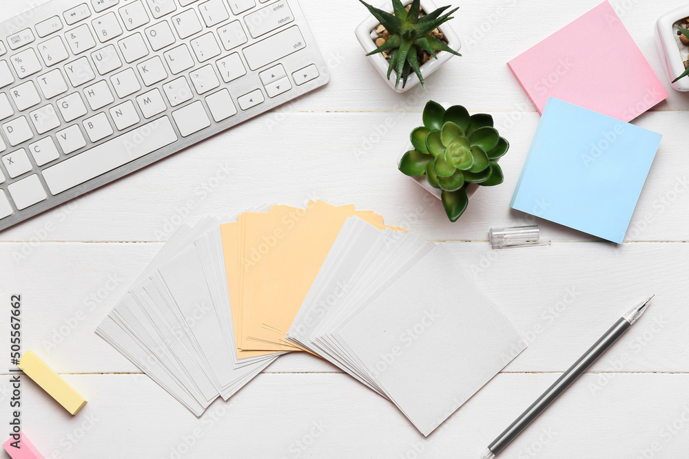 Blank sticky notes, houseplants, pen and keyboard on white wooden background Blank sticky notes, houseplants, pen and keyboard on white wooden background