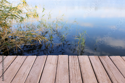 Wooden pier on river backgr...