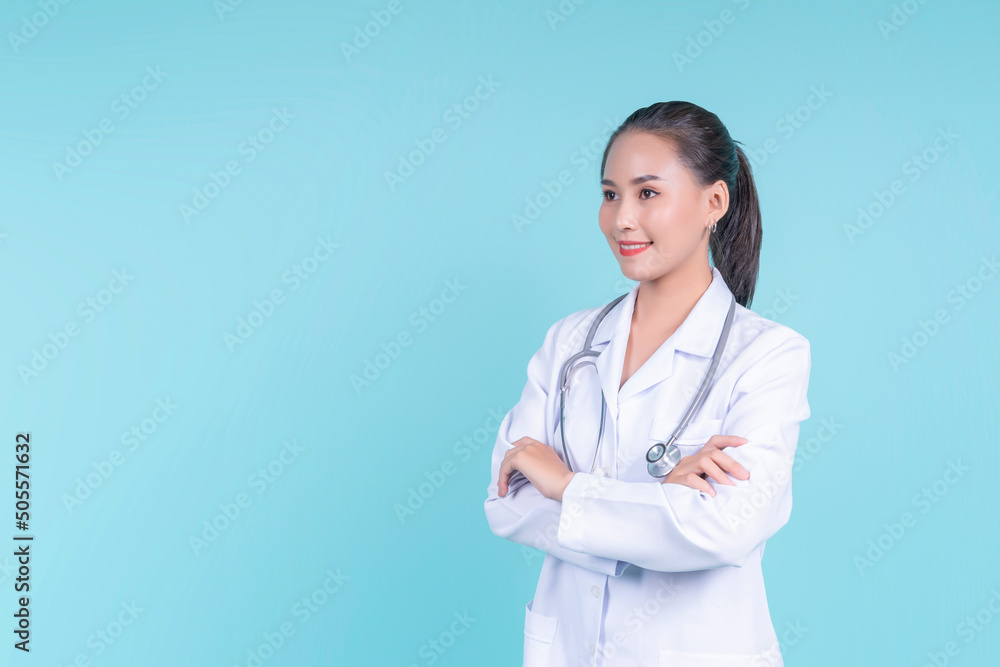 Happy smiling attractive Asian female woman doctor arms crossed confident, medical health care worker scientist clinical specialist expert in lab coat stethoscope, copyspace blue isolated background Happy smiling attractive Asian female woman doctor arms crossed confident, medical health care worker scientist clinical specialist expert in lab coat stethoscope, copyspace blue isolated background