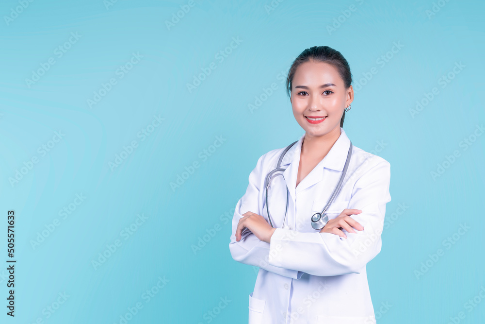 Happy smiling attractive Asian female woman doctor arms crossed confident, medical health care worker scientist clinical specialist expert in lab coat stethoscope, copyspace blue isolated background Happy smiling attractive Asian female woman doctor arms crossed confident, medical health care worker scientist clinical specialist expert in lab coat stethoscope, copyspace blue isolated background