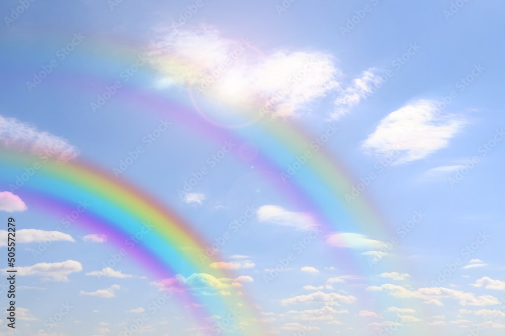 Beautiful view of bright rainbows in blue sky on sunny day Beautiful view of bright rainbows in blue sky on sunny day