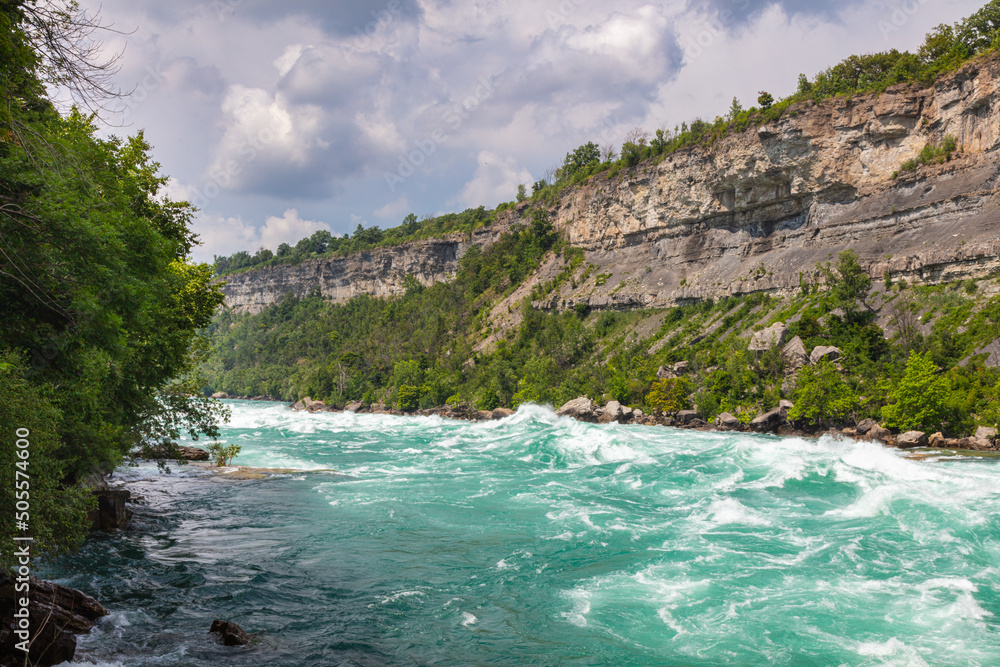 Rapids in the Niagara River near the so called whirlpool at the nagar falls. The river winds through the high gorges with immense speed. Niagara Falls is a must-see for tourists in Canada