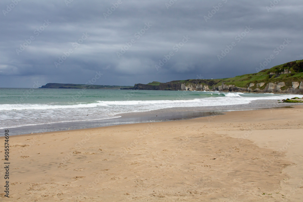 The beach and shoreline at Port Ballintrae ion the causeway coast in Northern Ireland