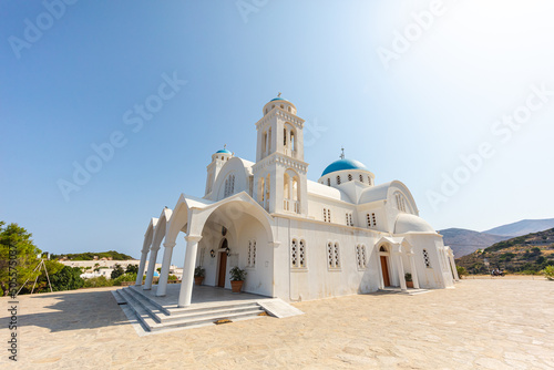 Paros, Greece - August 3, 2021: Holy Parish Church Pantanassis at Naoussa Paros. Paros a Greek island in the central Aegean Sea in the Cyclades island. The church with white masonry and blue roof