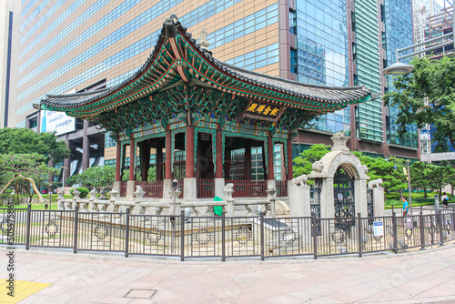 Seoul, South Korea - July 24, 2021: Traditional wooden Tempel in between the skyscrapers of the south Korean metropolis Seoul. This little temple shape the cityscape of Seoul, the capital Korea