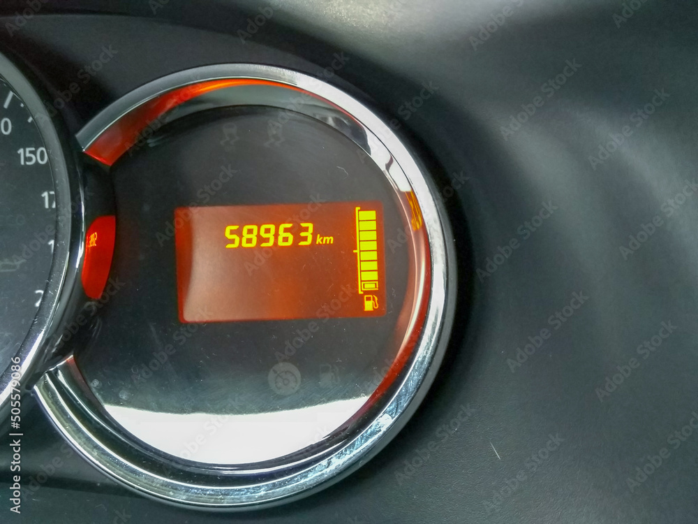 Fototapeta Car dashboard showing the ridden kilometers and fuel amount
