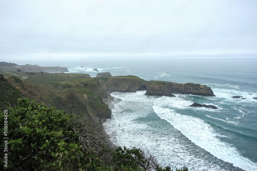 A beautiful view of the rugged shoreline of the northern california coast driving along highway 1, with rugged endless views of the ocean and rocky cliffs
